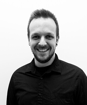 A black and white image of Andrew smiling.